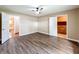 This bedroom features a ceiling fan, wood-look floors and access to a full bathroom at 119 Lake Dr, Oviedo, FL 32765