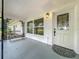 Welcoming front porch with stylish entry door, decorative metal accents and a seating bench at 119 Lake Dr, Oviedo, FL 32765