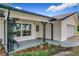 Inviting front porch with decorative columns and well-manicured landscaping at 119 Lake Dr, Oviedo, FL 32765