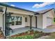 Inviting front porch with decorative ironwork, a stylish entrance door, and manicured landscaping at 119 Lake Dr, Oviedo, FL 32765