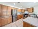 Galley kitchen featuring stainless appliances, wood cabinets, and durable countertops for a functional cooking space at 119 Lake Dr, Oviedo, FL 32765
