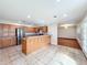 Open concept kitchen with stainless steel appliances, wood cabinets, and tile flooring offering ample space for dining at 119 Lake Dr, Oviedo, FL 32765