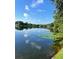 Picturesque lake view reflecting the sky, framed by trees, highlighting the natural beauty of the property at 119 Lake Dr, Oviedo, FL 32765