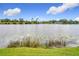 Backyard with lake view, showcasing the serene water and distant homes at 119 Lake Dr, Oviedo, FL 32765