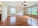 A living room features hardwood floors and large windows for natural light and neighborhood views at 119 Lake Dr, Oviedo, FL 32765