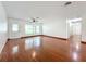 Inviting living room with hardwood floors, a ceiling fan, and a front door allowing ample natural light at 119 Lake Dr, Oviedo, FL 32765