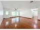 Inviting living room featuring hardwood floors, a ceiling fan, and a large window at 119 Lake Dr, Oviedo, FL 32765