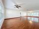 Spacious living room featuring hardwood floors, a ceiling fan, and natural light from large windows at 119 Lake Dr, Oviedo, FL 32765