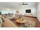 Spacious living room featuring hardwood floors, large sectional sofa, and a rustic coffee table at 119 Lake Dr, Oviedo, FL 32765