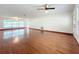 Spacious living room features hardwood floors and multiple windows for natural light at 119 Lake Dr, Oviedo, FL 32765