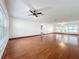 Spacious living room with hardwood floors, large windows, and a ceiling fan at 119 Lake Dr, Oviedo, FL 32765