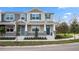 Charming townhome with a welcoming porch, blue door, decorative shutters, and manicured landscaping at 1267 Tarflower Dr, Winter Springs, FL 32708