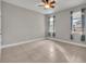 Empty bedroom with tile floors and two windows at 15583 Hamlin Blossom Ave, Winter Garden, FL 34787