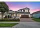 Two-story house with a brown door and attached garage at 15583 Hamlin Blossom Ave, Winter Garden, FL 34787