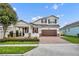 Two-story house with a brown door and attached garage at 15583 Hamlin Blossom Ave, Winter Garden, FL 34787