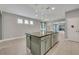 Kitchen island with granite countertop and green cabinets at 15583 Hamlin Blossom Ave, Winter Garden, FL 34787