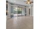 Living room with tile floors and sliding glass doors to patio at 15583 Hamlin Blossom Ave, Winter Garden, FL 34787