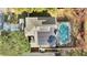 Aerial view of the home featuring a pool, screened patio and solar panels at 1000 Manigan Ave, Oviedo, FL 32765