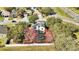 Aerial view of a house with a pool, surrounded by lush trees, in a suburban neighborhood at 1000 Manigan Ave, Oviedo, FL 32765