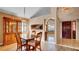 Inviting dining room features wood flooring, a classic hutch, and a seamless transition to the entry foyer and kitchen at 1000 Manigan Ave, Oviedo, FL 32765