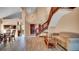 Welcoming foyer with wood-look tile, staircase, and views into the dining area, living room, and kitchen at 1000 Manigan Ave, Oviedo, FL 32765