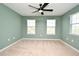 Bedroom features neutral carpet, a ceiling fan, and windows at 2129 Victoria Glen Dr, Sanford, FL 32773