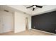 An interior view of a spacious bedroom with neutral carpeting, a black accent wall, and white trim at 2129 Victoria Glen Dr, Sanford, FL 32773