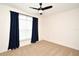 Bedroom features neutral carpet, a ceiling fan, and a window with dark curtains at 2129 Victoria Glen Dr, Sanford, FL 32773