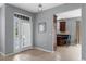 Inviting foyer with tile floors, a modern light fixture, and a view into the adjacent kitchen at 2129 Victoria Glen Dr, Sanford, FL 32773