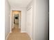 Hallway view showcasing neutral paint and carpet, leading to the Primary bedroom at 2129 Victoria Glen Dr, Sanford, FL 32773