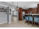 Modern kitchen with stainless steel appliances, dark wood cabinetry, and a breakfast bar with blue chairs at 2129 Victoria Glen Dr, Sanford, FL 32773