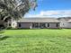 House's back view with large green backyard at 3904 Plantation Blvd, Leesburg, FL 34748