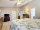 Primary bedroom with a king-size bed, dresser, and ceiling fan at 3904 Plantation Blvd, Leesburg, FL 34748