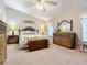 Spacious Primary bedroom with a king-size bed and wooden furniture at 3904 Plantation Blvd, Leesburg, FL 34748