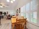 Bright breakfast nook with wood table and chairs and view into the dining room at 3904 Plantation Blvd, Leesburg, FL 34748