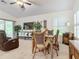 Dining area with a wood table and chairs near a relaxing seating area at 3904 Plantation Blvd, Leesburg, FL 34748