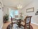 Dining room with glass-top table and chandelier at 3904 Plantation Blvd, Leesburg, FL 34748