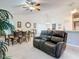 Casual dining area with a brown leather couch and view into kitchen at 3904 Plantation Blvd, Leesburg, FL 34748