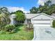 Gray house with a two-car garage and well-manicured lawn at 3904 Plantation Blvd, Leesburg, FL 34748