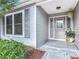 Front door entryway with gray door and sidelights at 3904 Plantation Blvd, Leesburg, FL 34748