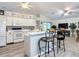 Bright eat-in kitchen with white cabinets, tile backsplash, and island at 3904 Plantation Blvd, Leesburg, FL 34748