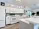 White kitchen features stainless steel appliances and tile flooring at 3904 Plantation Blvd, Leesburg, FL 34748