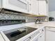 Close up view of the kitchen stovetop and backsplash at 3904 Plantation Blvd, Leesburg, FL 34748