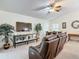 Relaxing living room with a large TV, comfortable seating, and potted plants at 3904 Plantation Blvd, Leesburg, FL 34748