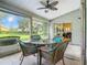 Screened porch features ceiling fan and outdoor seating area at 3904 Plantation Blvd, Leesburg, FL 34748