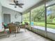 Screened porch with ceiling fan, wicker furniture, and backyard view at 3904 Plantation Blvd, Leesburg, FL 34748