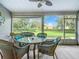 Relaxing screened porch with wicker furniture and view of backyard at 3904 Plantation Blvd, Leesburg, FL 34748