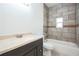 Modern bathroom featuring a shower and tub combo with neutral tile and dark vanity at 1740 Palm Rd, Ormond Beach, FL 32174