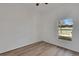 Bright bedroom featuring wood-look floors and a window allowing natural light at 1740 Palm Rd, Ormond Beach, FL 32174