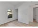 A bright bedroom showcasing wood-look floors, closet, and access to the hallway at 1740 Palm Rd, Ormond Beach, FL 32174